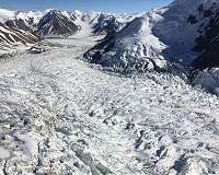 Tiny sand grains trigger massive glacial surges