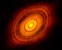 Birth of planets revealed in concentric rings of comets, asteroids and dust
