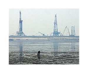 China agency sued over oil production in spill-hit bay