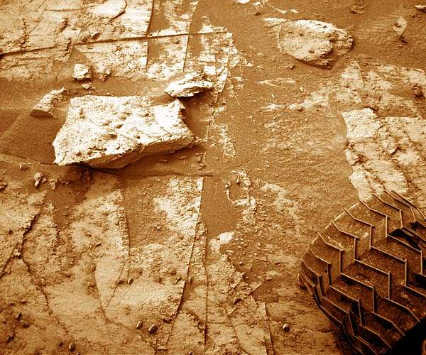 Sol 3350-3352: A Rock Under the Wheel