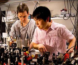 Quantum teleportation between atomic systems over long distances