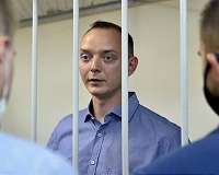 Supporters detained as Russia charges ex-reporter with treason
