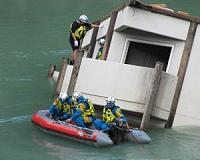 Japan rescuers battle to reach thousands trapped by floods