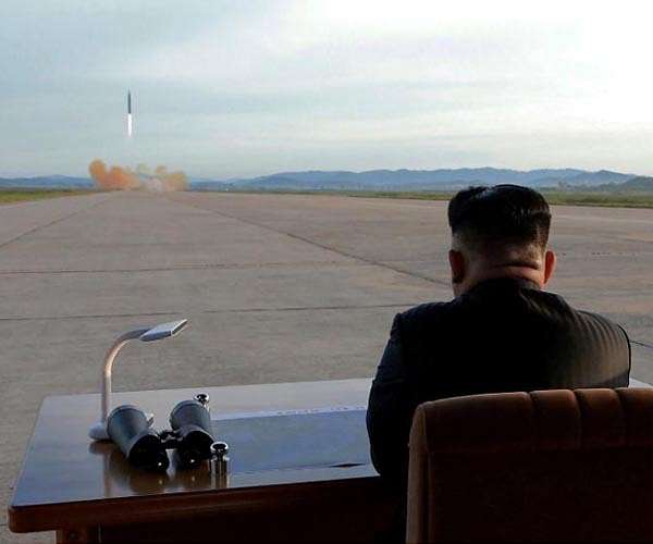 North Korea's Kim praises scientists after 'satellite' test