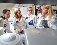Two doctoral students work on NASA mission