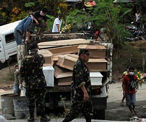 Philippines buries its dead as flood toll tops 1,000