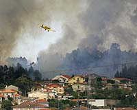 Firefighters battle wildfires in Portugal, Spain