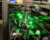 Laser experiment reveals liquid-like motion of atoms in an ultra-cold cluster