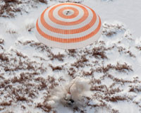 Three-man multinational space crew returns to Earth