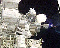US Atlantis Astronauts Step Out On Space Walk